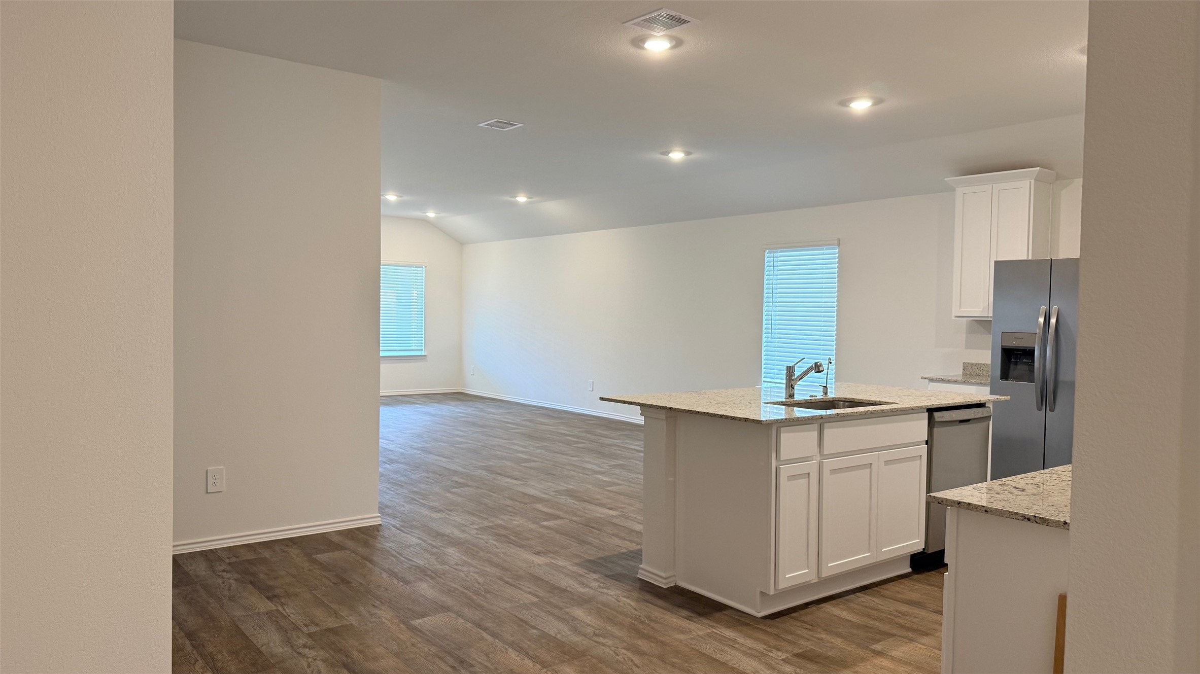 3807 Axyl Run Fulshear, TX 77423 - Photo 7 of 29 a kitchen with stainless steel appliances a sink and a refrigerator