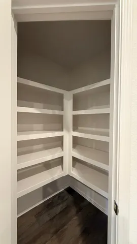 a view of walk in closet with empty racks