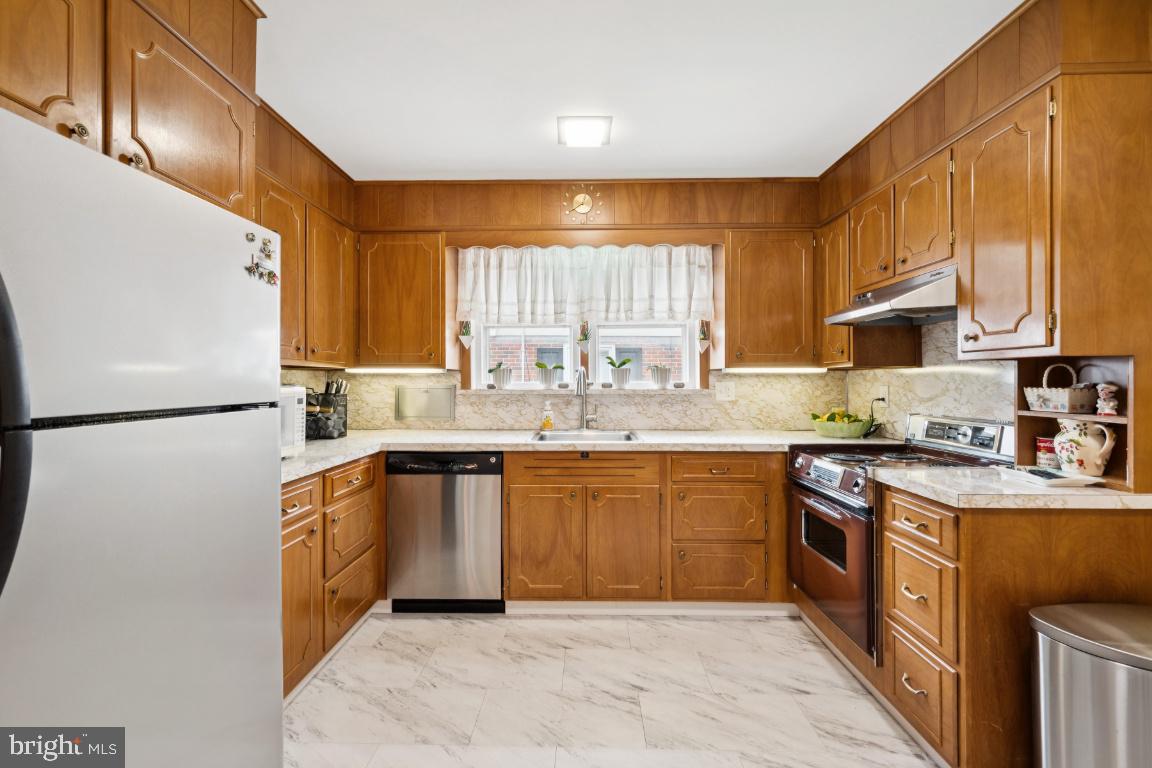 1608 Prospect Ridge Boulevard Haddon Heights, NJ 08035 - Photo 13 of 28 a kitchen with stainless steel appliances granite countertop a sink a stove a refrigerator cabinets and a window