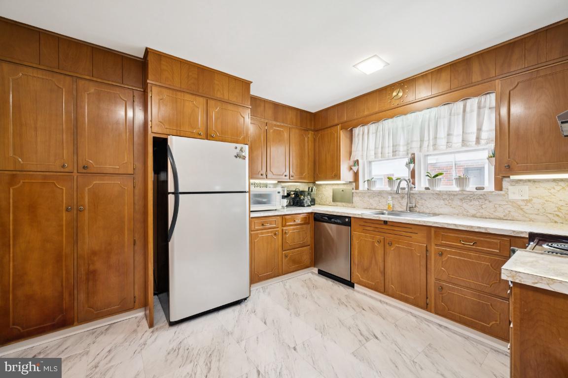 1608 Prospect Ridge Boulevard Haddon Heights, NJ 08035 - Photo 14 of 28 a kitchen with a refrigerator sink and cabinets