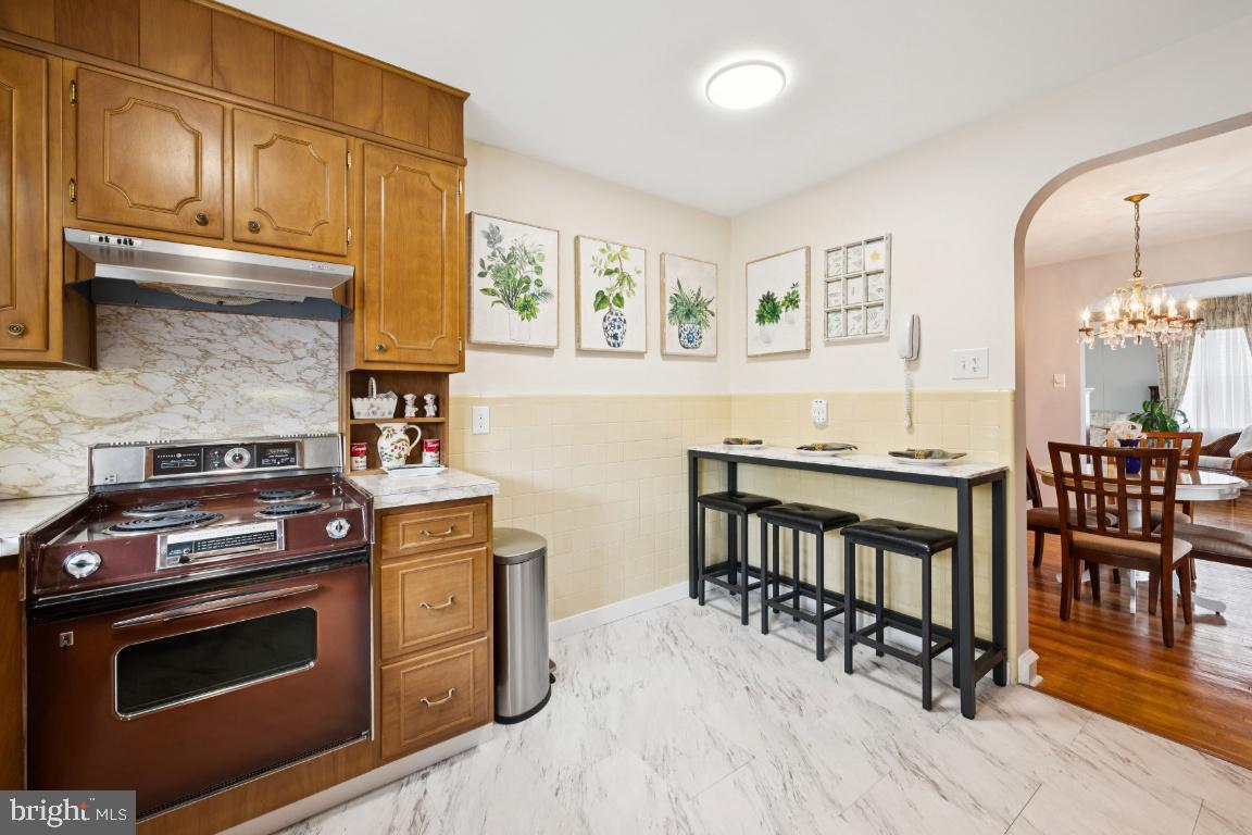 1608 Prospect Ridge Boulevard Haddon Heights, NJ 08035 - Photo 15 of 28 a kitchen with stainless steel appliances wooden floor stove top oven and cabinets