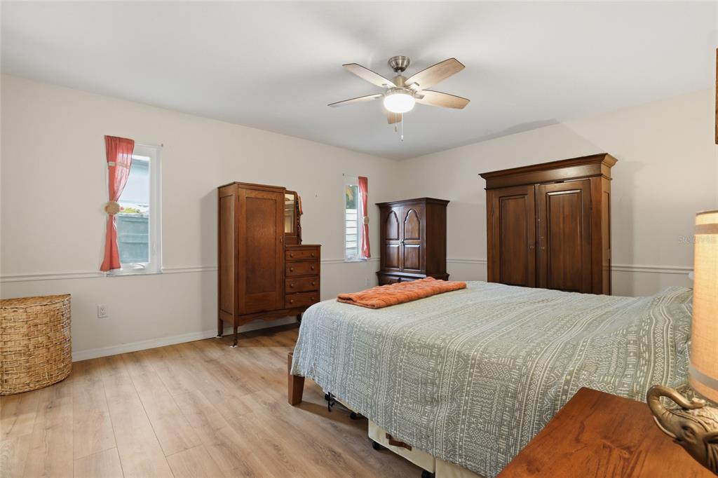 4576 Bliss Road Sarasota, FL 34233 - Photo 20 of 40 a bedroom with a bed and a chandelier