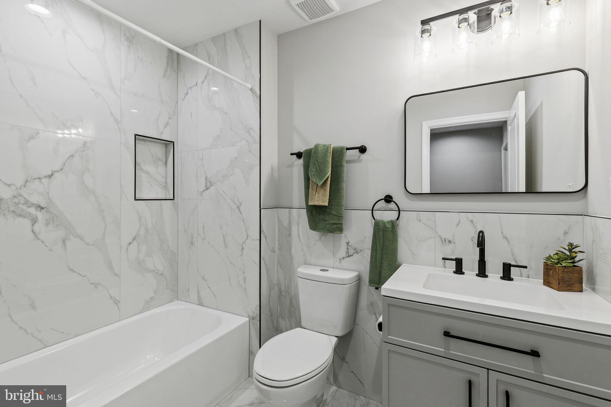 2245 East Preston Street Baltimore, MD 21213 - Photo 11 of 24 a bathroom with a toilet sink and bathtub