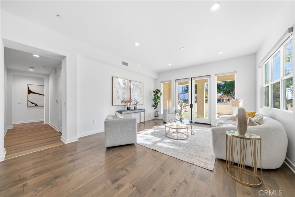 148 Follyhatch Irvine, CA 92618 - Photo 11 of 33 a living room with fireplace furniture and a wooden floor