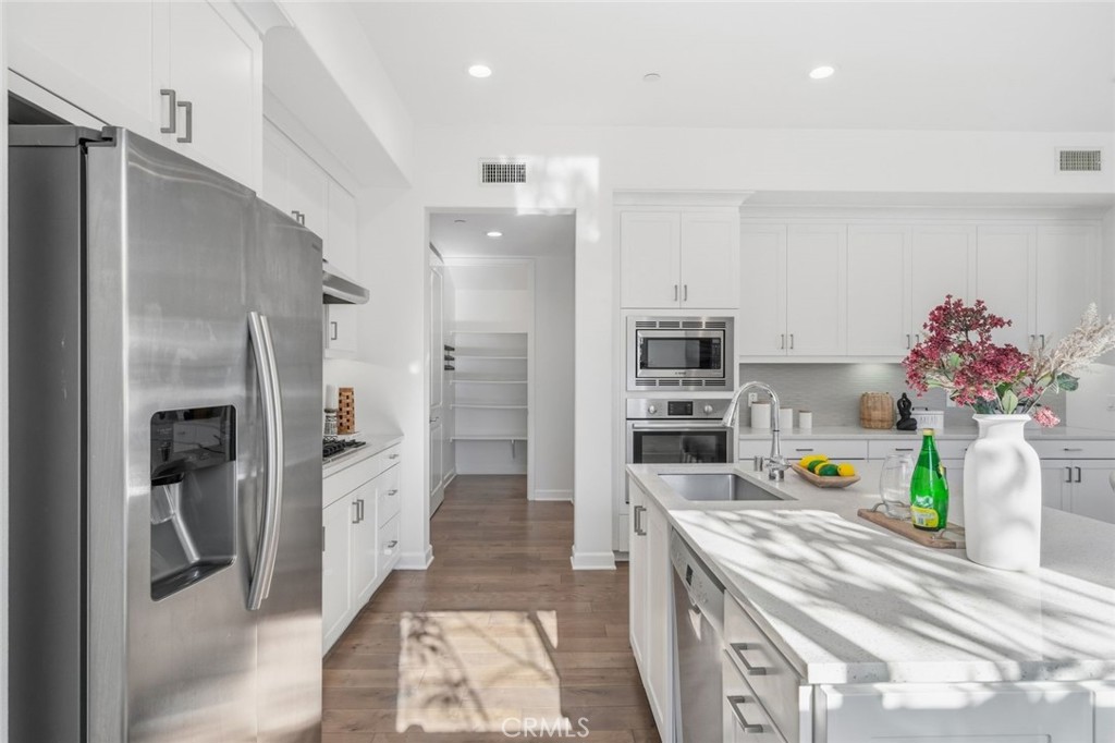 148 Follyhatch Irvine, CA 92618 - Photo 15 of 33 a kitchen with refrigerator and cabinets