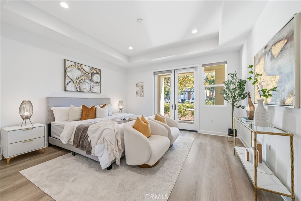 148 Follyhatch Irvine, CA 92618 - Photo 17 of 33 a spacious bedroom with a bed and a couch