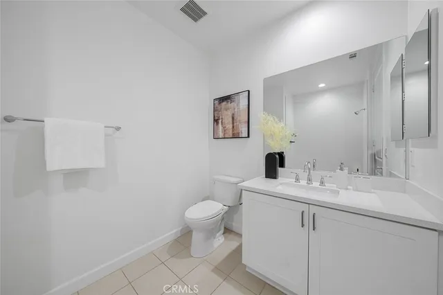 a view of bathroom with a sink toilet and mirror