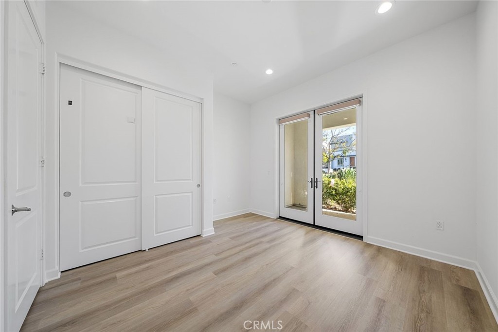 148 Follyhatch Irvine, CA 92618 - Photo 28 of 33 an empty room with wooden floor and natural light