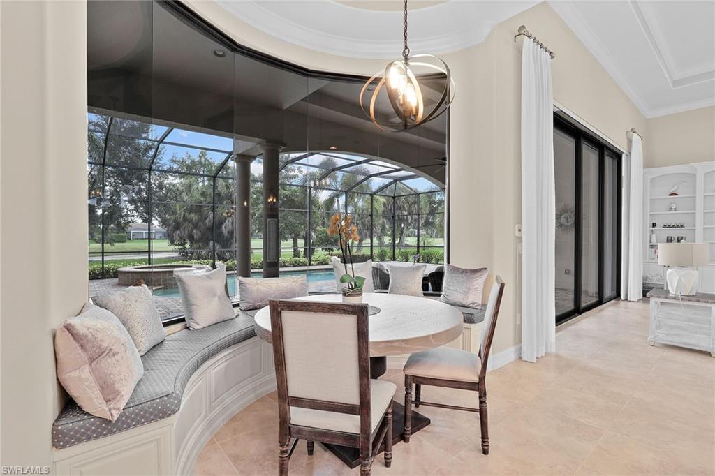 7440 Byrons Way Naples, FL 34113 - Photo 14 of 43 a dining room with furniture a chandelier and a floor to ceiling window