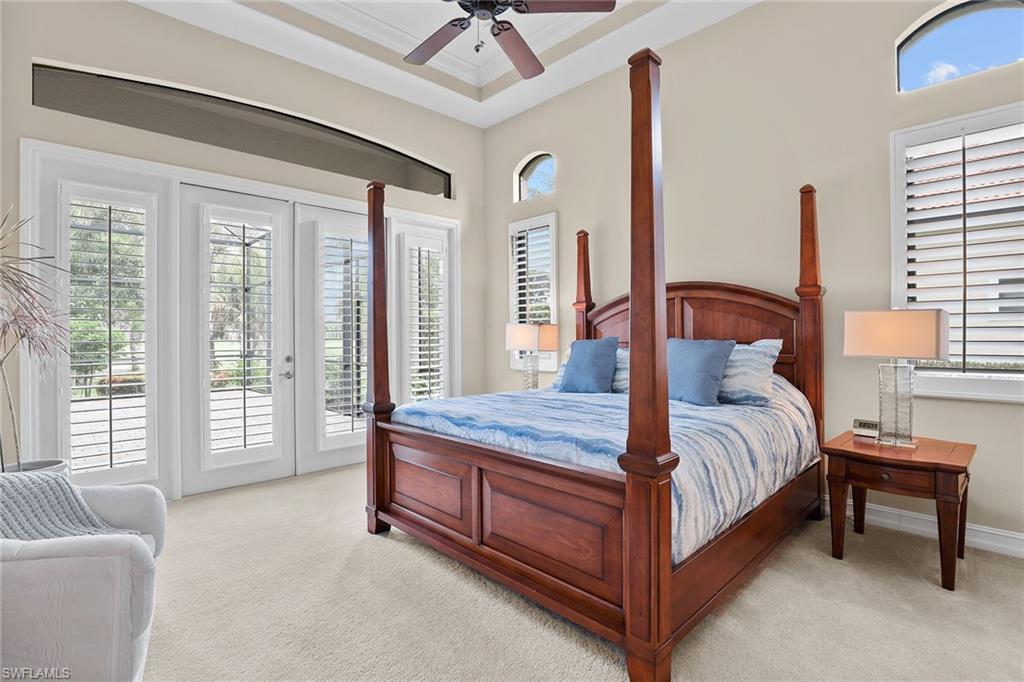 7440 Byrons Way Naples, FL 34113 - Photo 15 of 43 a bedroom with a bed and a large window