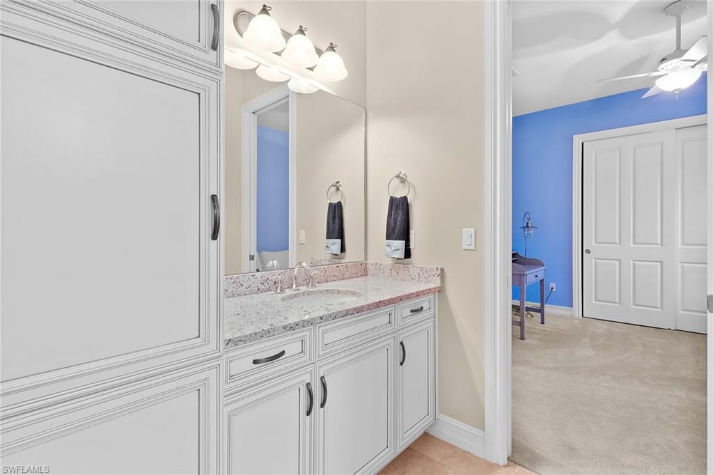7440 Byrons Way Naples, FL 34113 - Photo 20 of 43 a bathroom with a sink vanity and a mirror