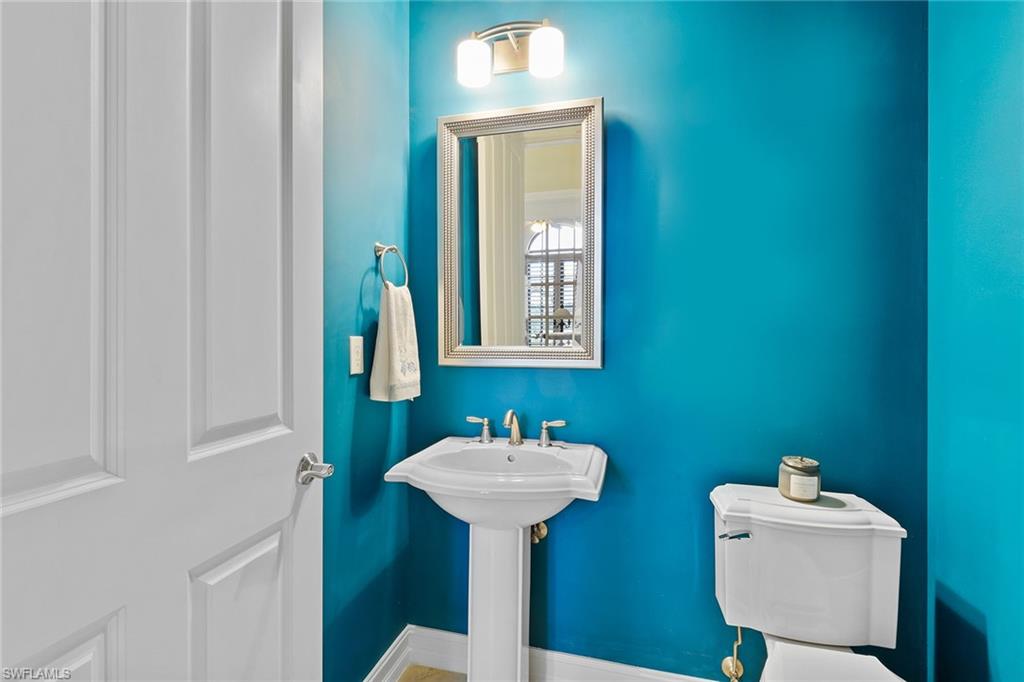 7440 Byrons Way Naples, FL 34113 - Photo 23 of 43 a bathroom with a sink a mirror and a window