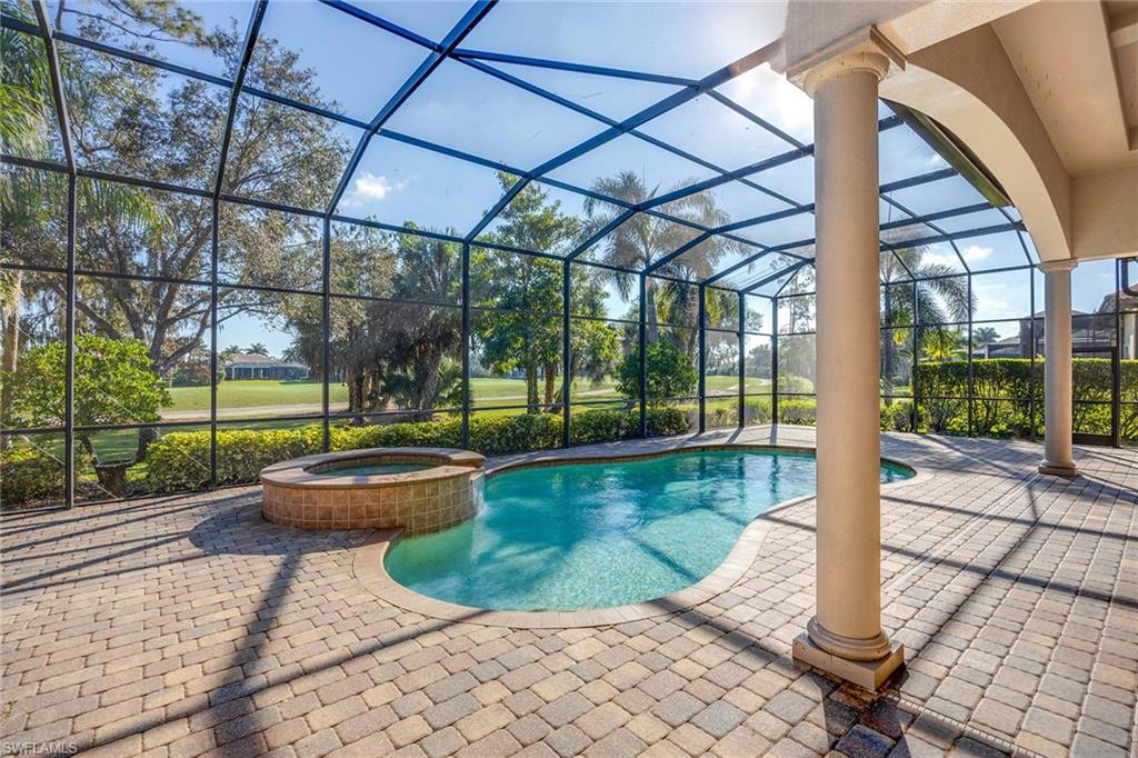 7440 Byrons Way Naples, FL 34113 - Photo 31 of 43 a view of a swimming pool with a patio