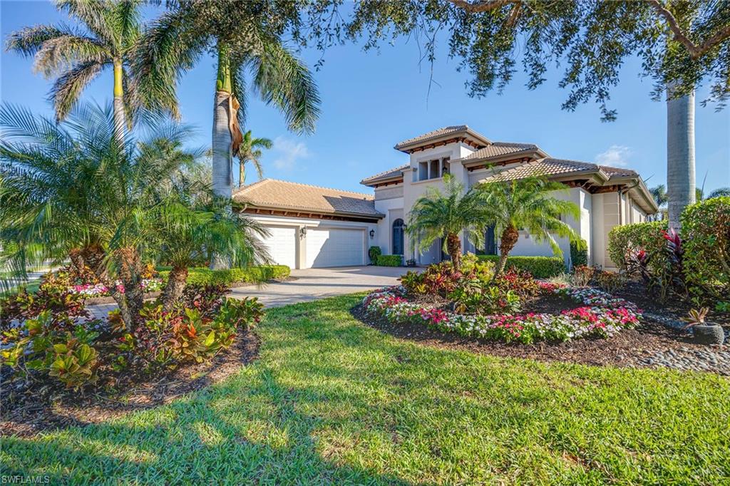 7440 Byrons Way Naples, FL 34113 - Photo 4 of 43 a view of a garden with a flower plants and a large tree