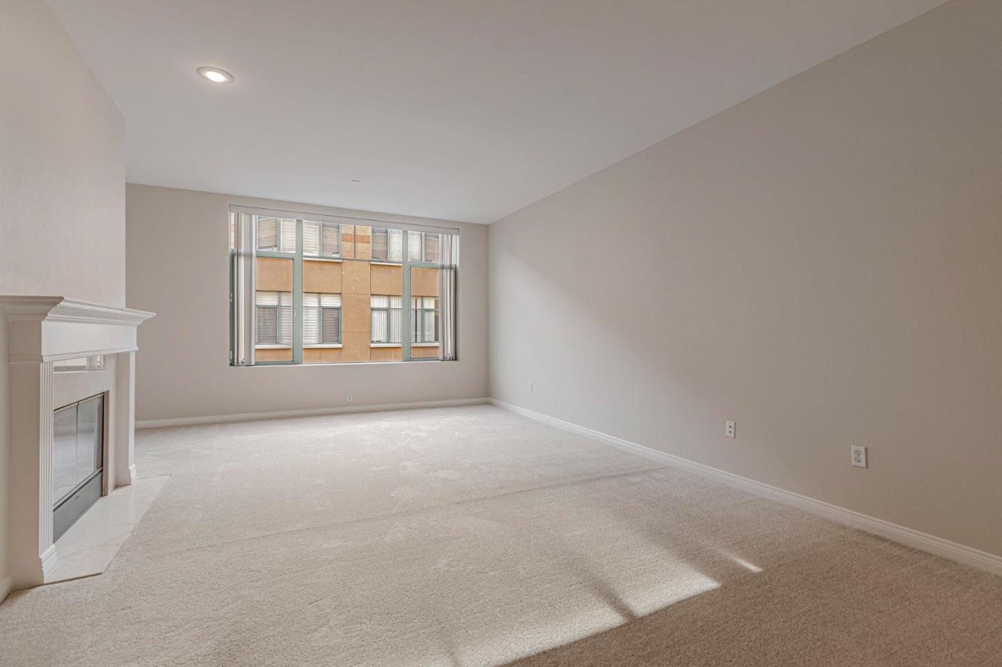 144 South 3rd Street, Unit 433 San Jose, CA 95112 - Photo 13 of 66 an empty room with a fireplace and windows