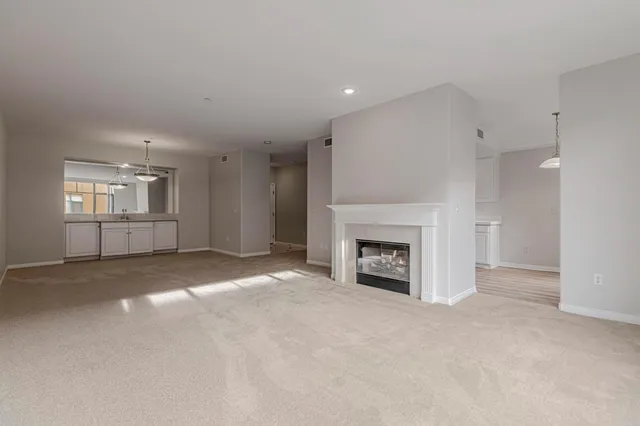 an empty room with a bathroom and mirror