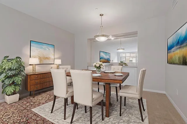 a view of a dining room with furniture and a potted plant