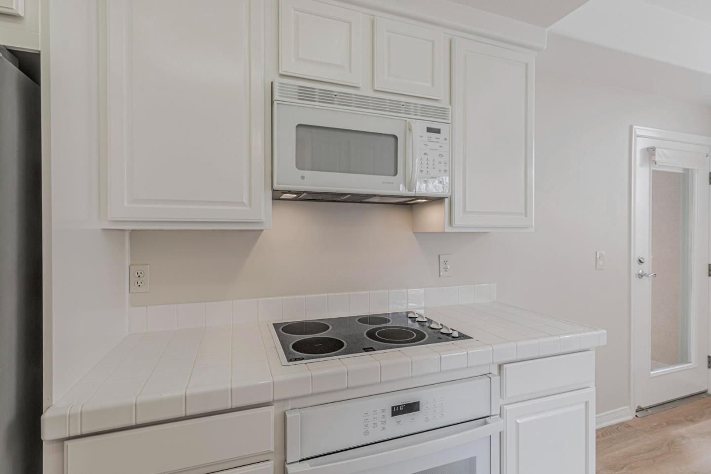 144 South 3rd Street, Unit 433 San Jose, CA 95112 - Photo 28 of 66 a kitchen with white cabinets and appliances