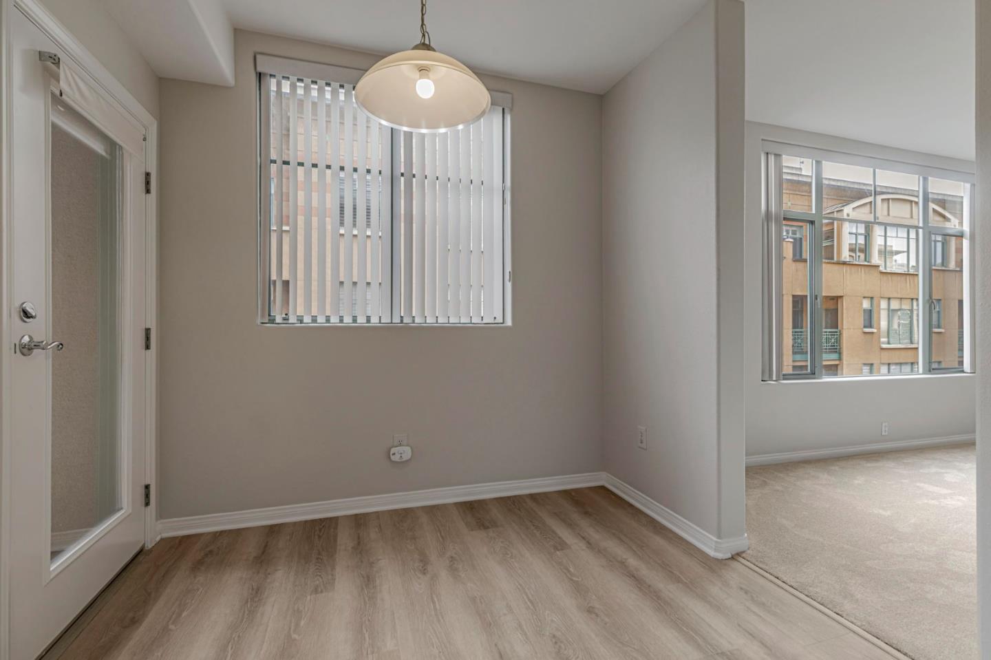 144 South 3rd Street, Unit 433 San Jose, CA 95112 - Photo 31 of 66 a view of an empty room with wooden floor and a window