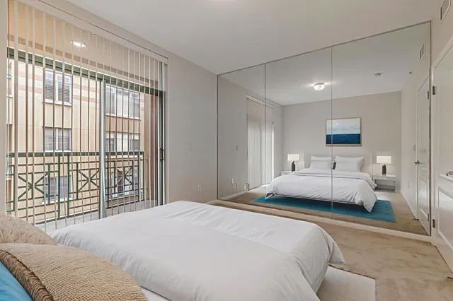 a bedroom with a large bed and a large window