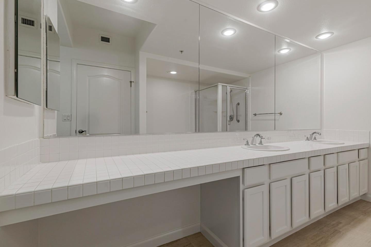 144 South 3rd Street, Unit 433 San Jose, CA 95112 - Photo 41 of 66 a bathroom with a sink a large mirror and a shower