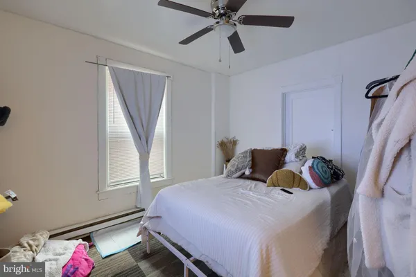a bedroom with a bed and window
