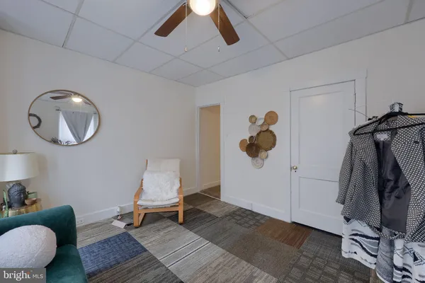 a living room with a couch and a mirror