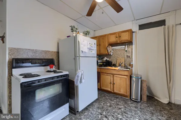 a kitchen with a refrigerator stove and white cabinets