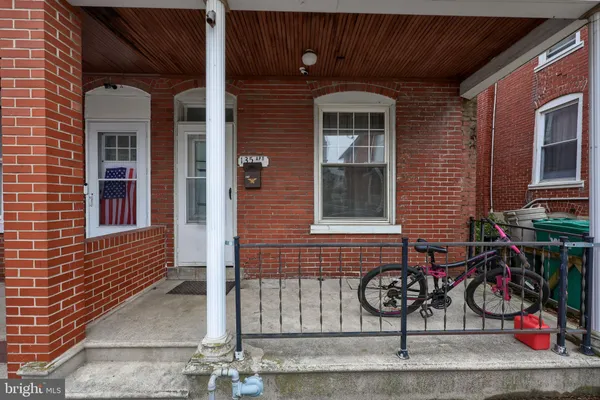 a front view of a house with porch and windows