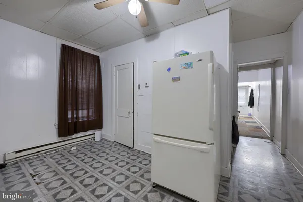a view of a hallway with a refrigerator and a stove