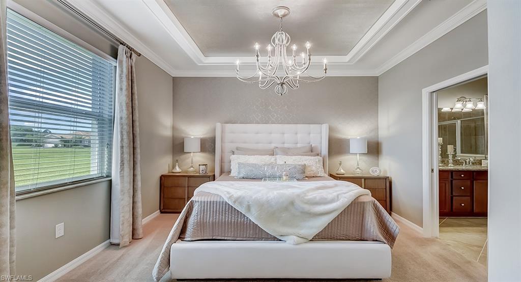 14916 Anchorage Road Punta Gorda, FL 33982 - Photo 13 of 20 a bedroom with a large bed and a chandelier
