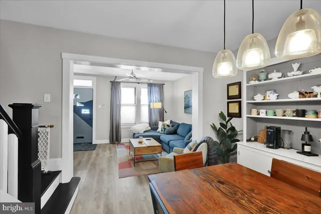 a living room with furniture a rug and a large mirror