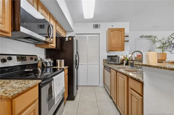 a kitchen with stainless steel appliances granite countertop a stove and a sink