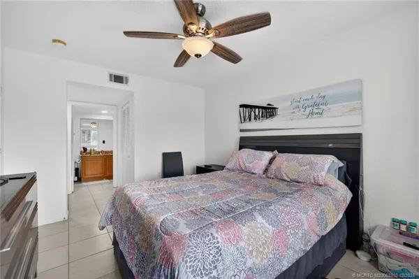 a bedroom with a bed and ceiling fan