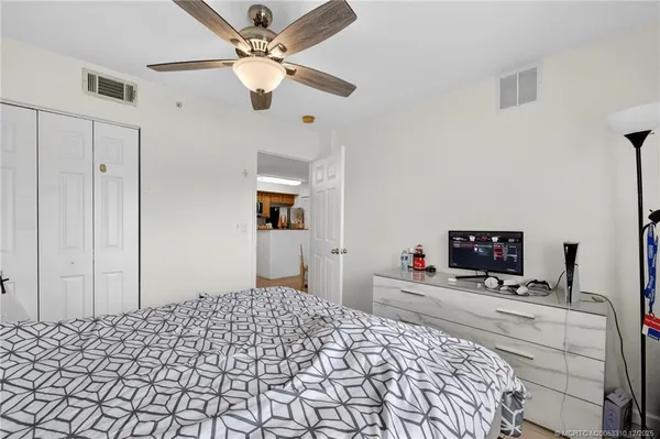 a bedroom with a bed and a chandelier