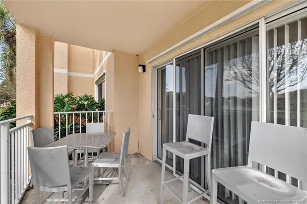 a view of a patio with table and chairs