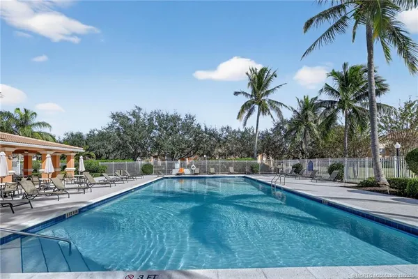a swimming pool with outdoor seating and yard