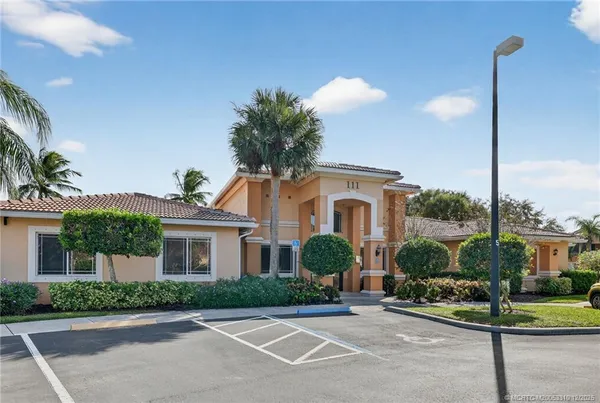 a front view of a house with a garden and plants