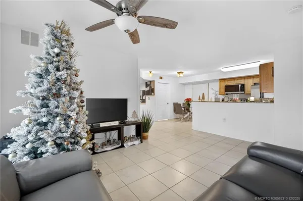 a living room with furniture and a potted plant