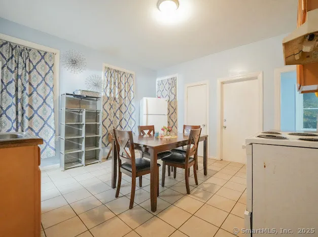 a dining room with furniture and window