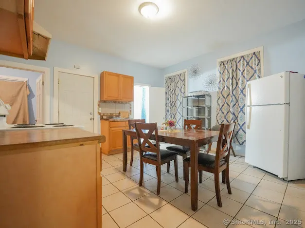 a view of a dining room with furniture and a chandelier