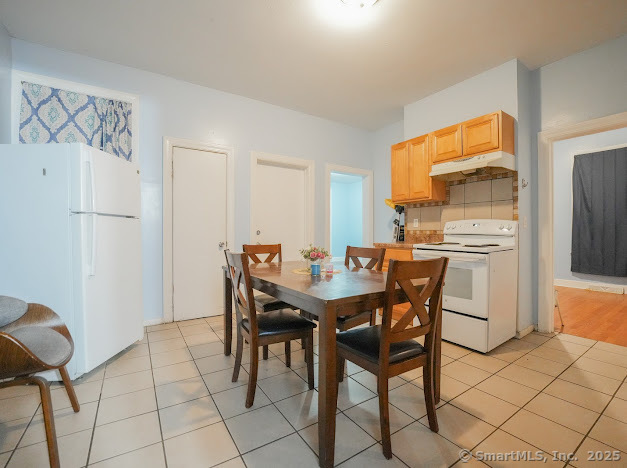 336 Legion Avenue, Unit 1 New Haven, CT 06519 - Photo 9 of 10 a dining room with furniture and a refrigerator