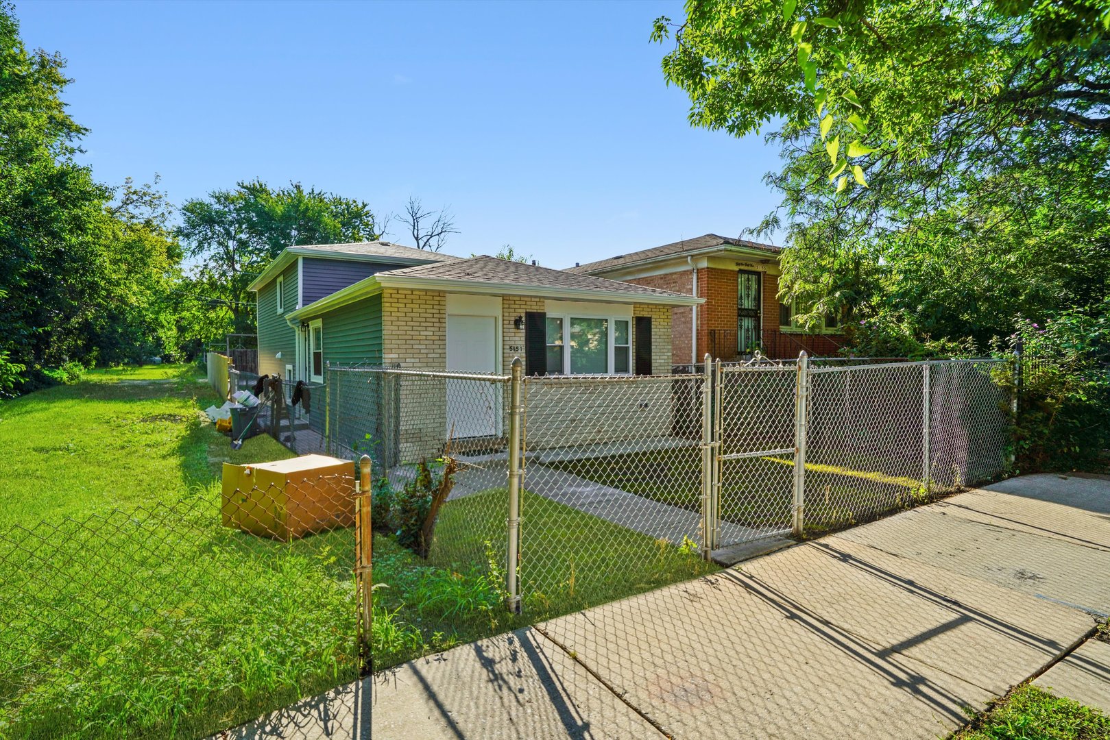 5151 South Emerald Avenue Chicago, IL 60609 - Photo 14 of 24 a backyard of a house with table and chairs potted plants and large tree