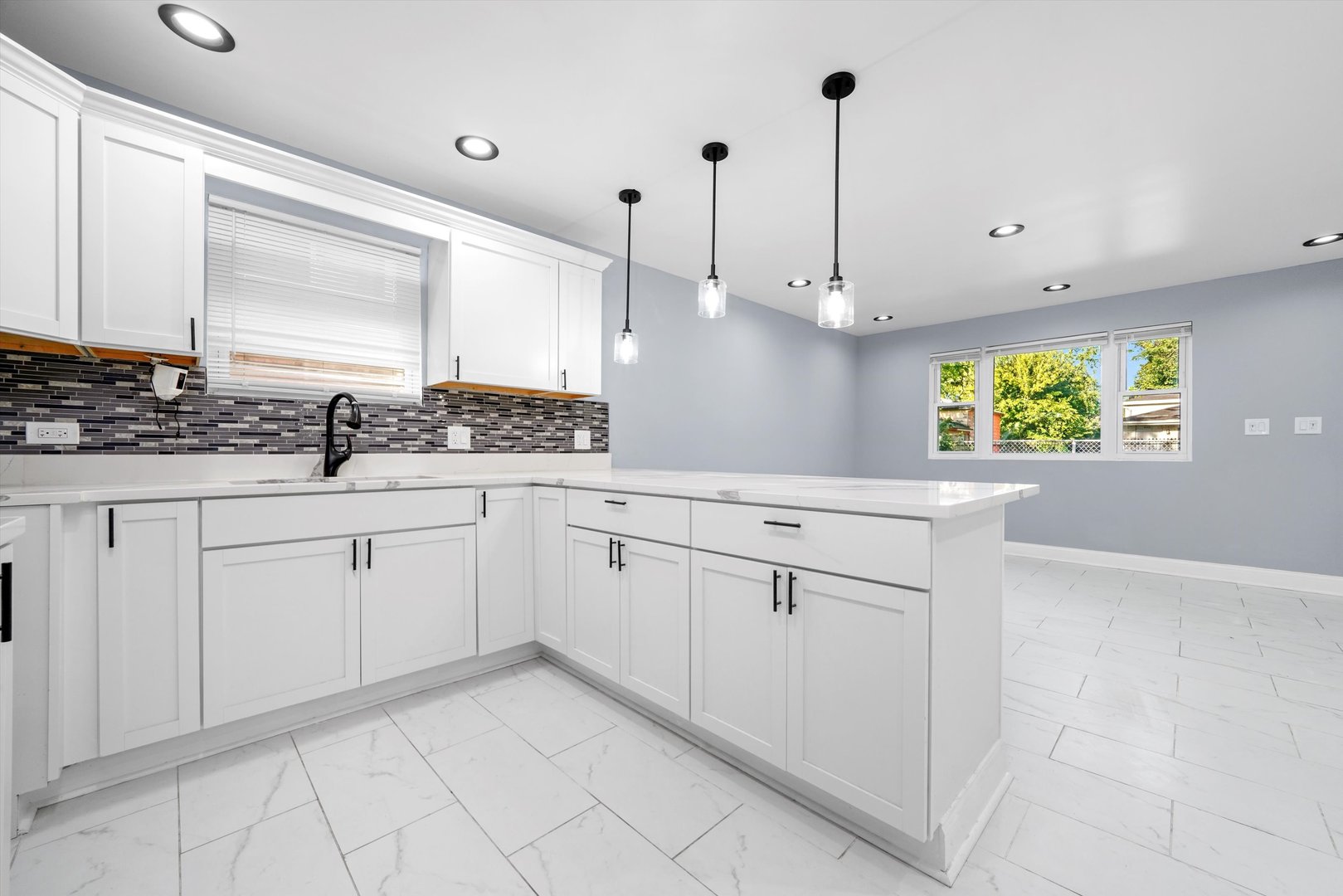 5151 South Emerald Avenue Chicago, IL 60609 - Photo 3 of 24 a kitchen with white cabinets and window