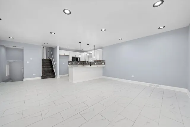 a view of a kitchen with white cabinets