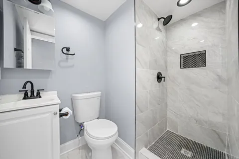 a bathroom with a sink toilet and shower