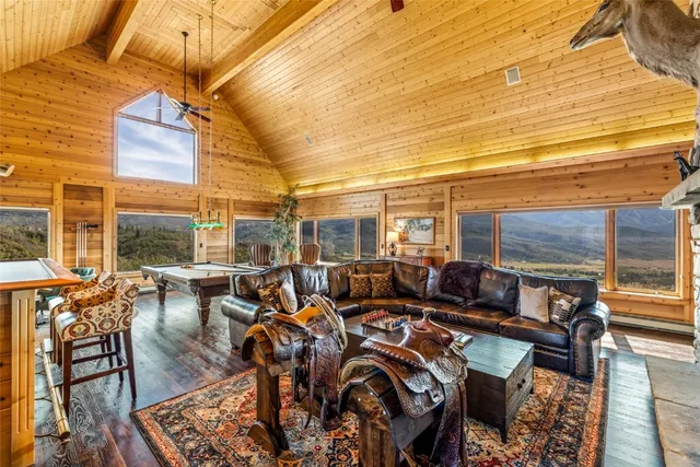 a view of a patio with couches chairs with wooden floor