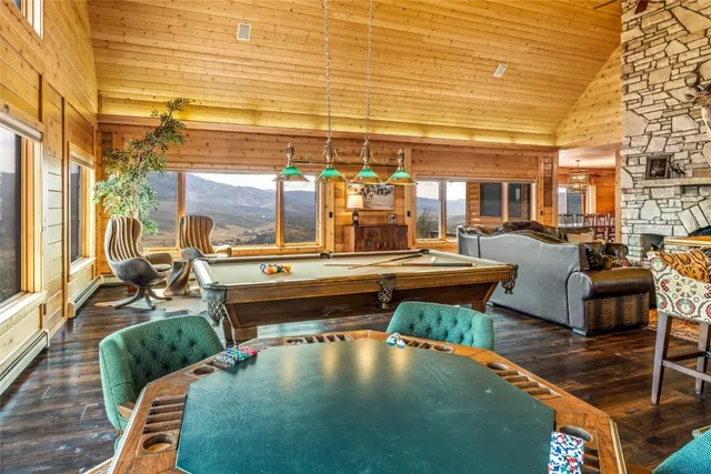 a view of a room with a large window and wooden floor