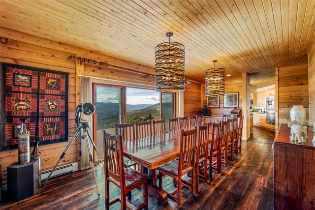 a view of a dining room with furniture a chandelier and wooden floor