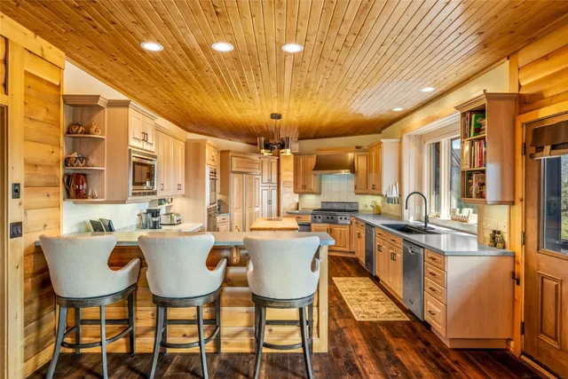 a kitchen with a stove a sink and a refrigerator